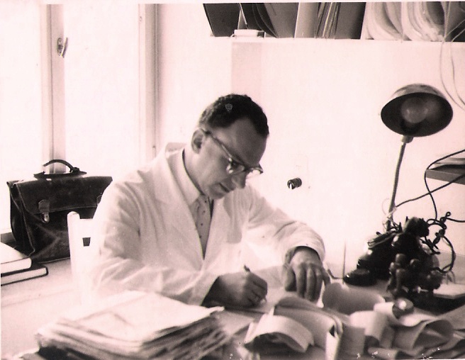 Dr. Gilboa Reading Papers at his Office